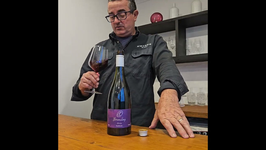 Matt Wenk tasting and holding a bottle of 2015 Heathcote Shiraz in a cellar environment